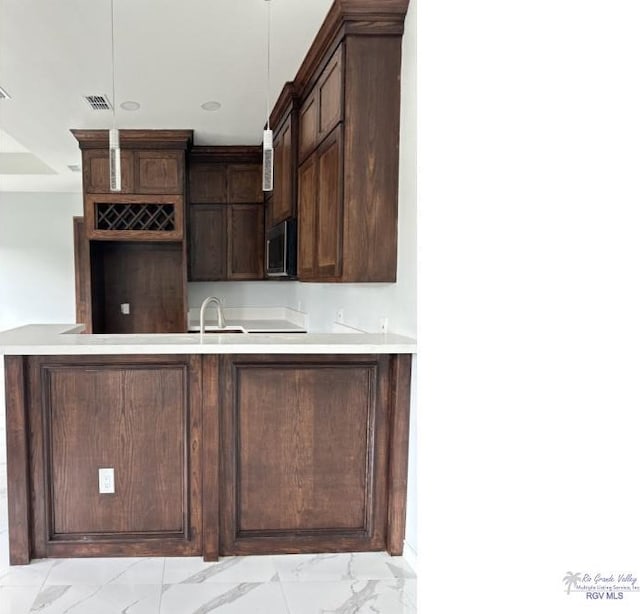 kitchen with dark brown cabinets and sink