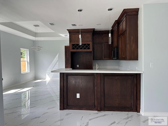 kitchen featuring dark brown cabinetry and pendant lighting