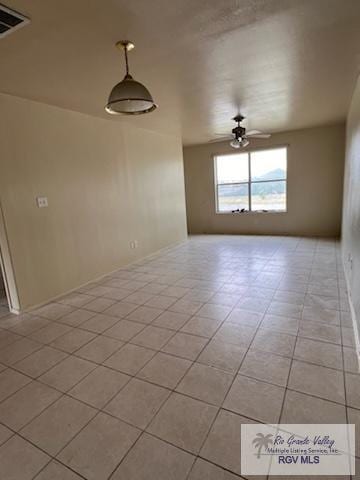 empty room featuring ceiling fan and light tile patterned floors