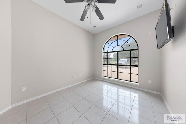 unfurnished room with ceiling fan and light tile patterned floors