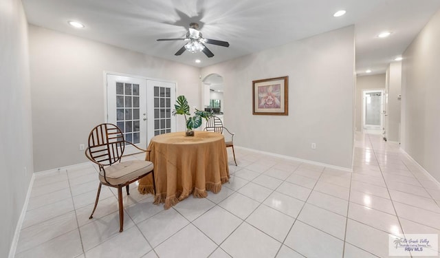 tiled dining area featuring ceiling fan and french doors