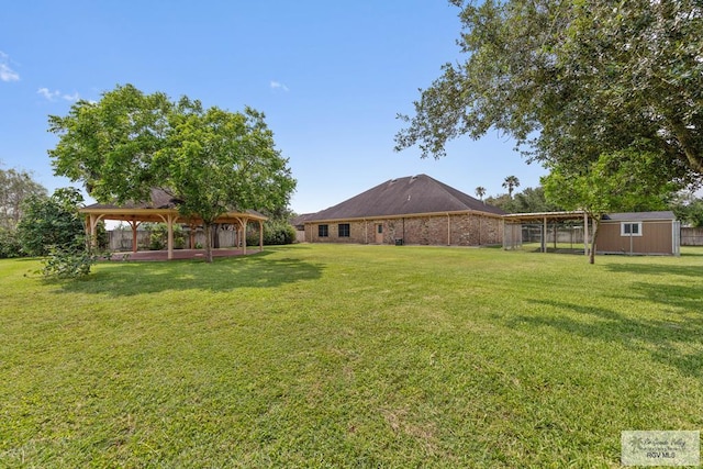 view of yard featuring a gazebo and a storage shed