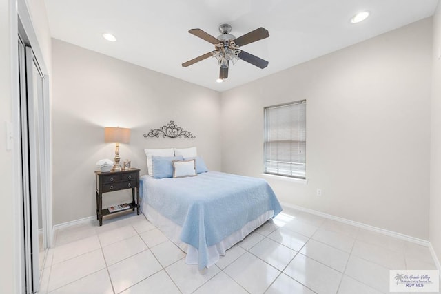 bedroom with ceiling fan, a closet, and light tile patterned floors