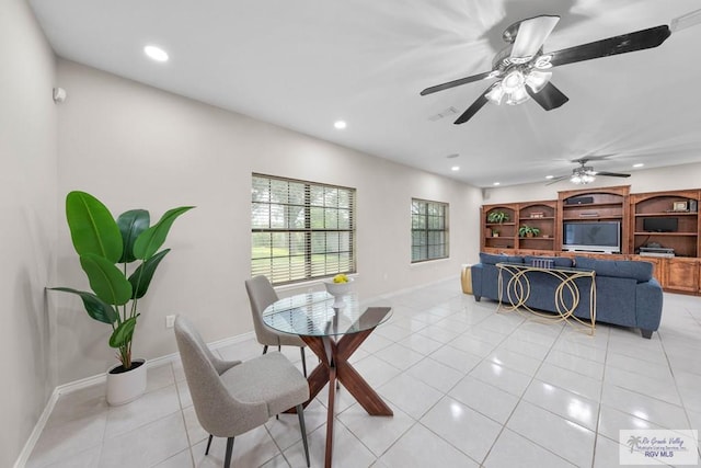 tiled dining room featuring ceiling fan