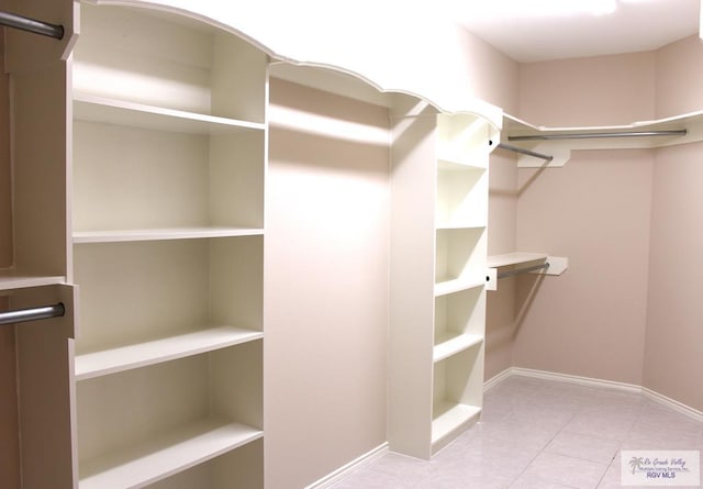 spacious closet featuring light tile patterned flooring