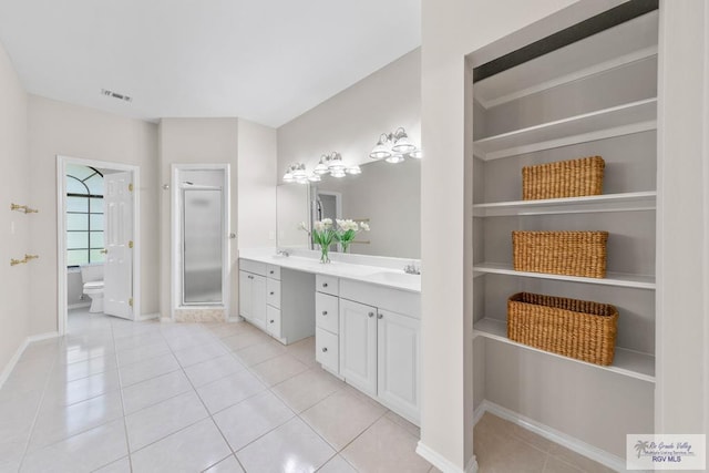 bathroom featuring tile patterned floors, vanity, and toilet