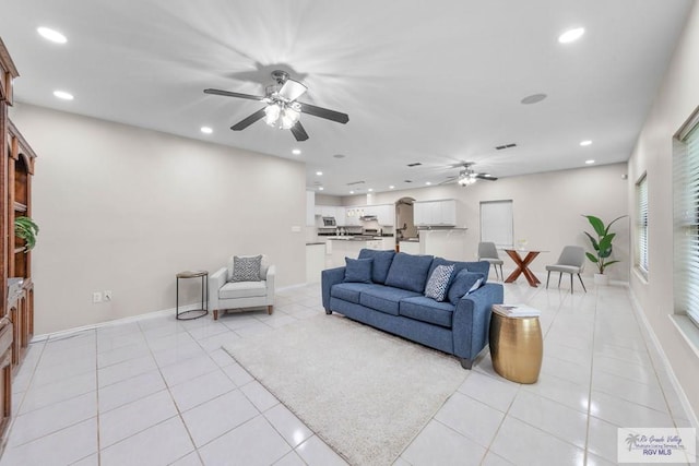 living room featuring ceiling fan and light tile patterned floors