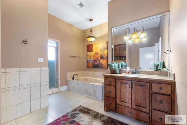 bathroom featuring tile patterned flooring, vanity, and shower with separate bathtub