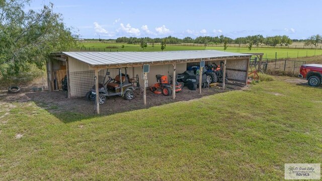 view of outdoor structure with a lawn and a rural view