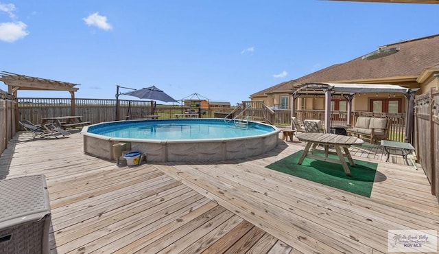 view of swimming pool featuring outdoor lounge area, a pergola, and a deck