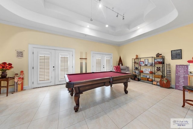 game room featuring pool table, light tile patterned flooring, a tray ceiling, and french doors