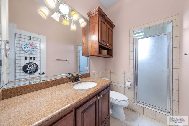 bathroom with walk in shower, tile patterned floors, toilet, vanity, and tile walls