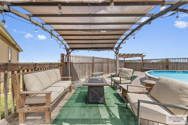 view of patio featuring a pergola, a fenced in pool, and an outdoor living space with a fire pit