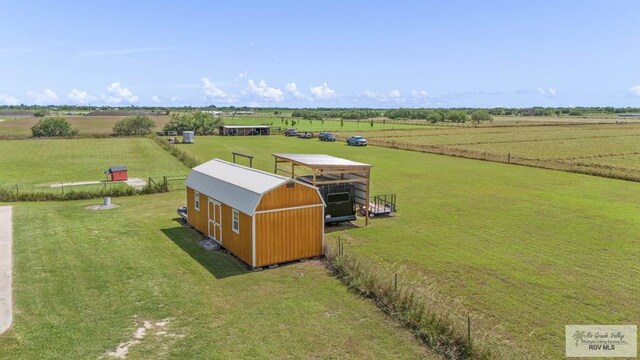 birds eye view of property with a rural view