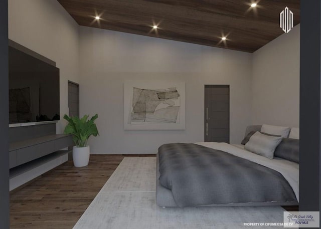 bedroom featuring a towering ceiling and wood finished floors