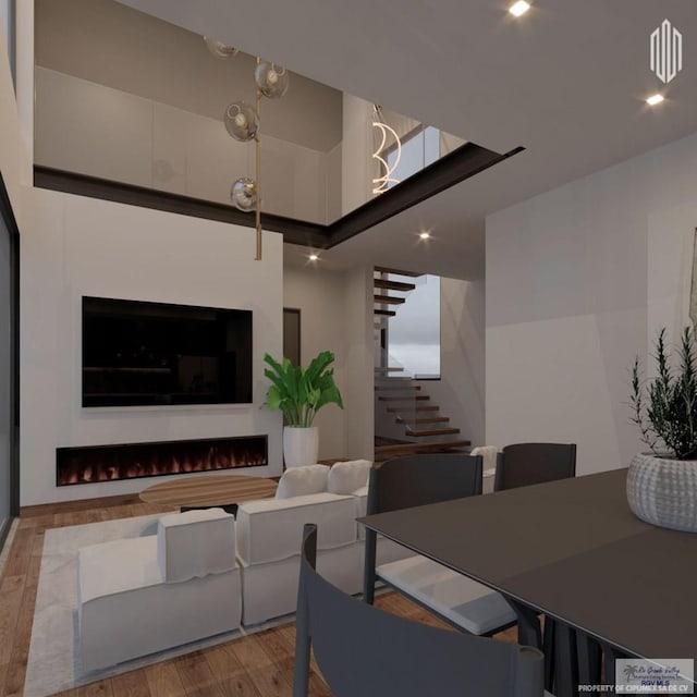 dining space featuring recessed lighting, wood finished floors, and stairs