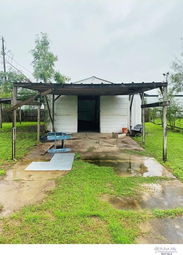 exterior space featuring a lawn and a carport