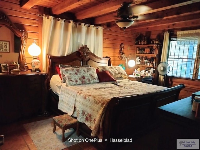 bedroom featuring tile patterned floors, beam ceiling, wood ceiling, and wooden walls