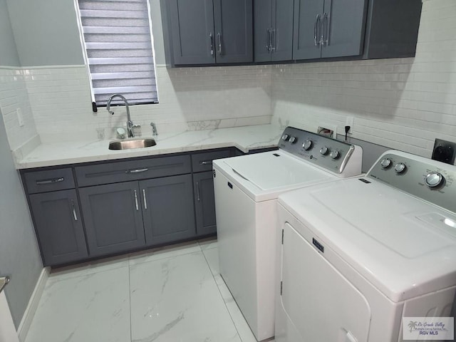 laundry area with cabinets, sink, and washing machine and clothes dryer