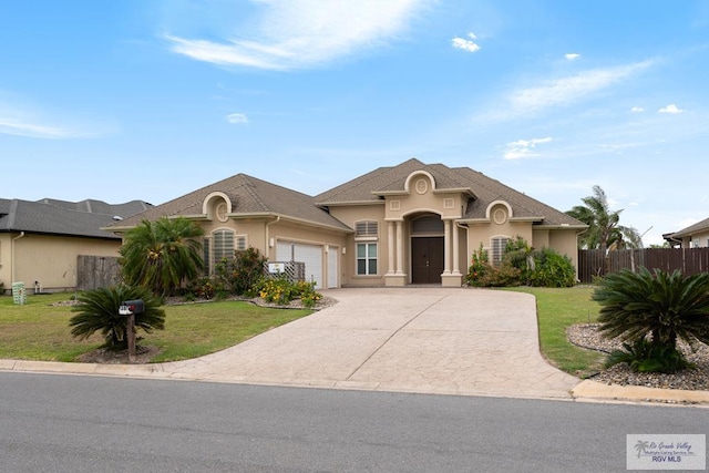 view of front of property featuring a garage and a front lawn