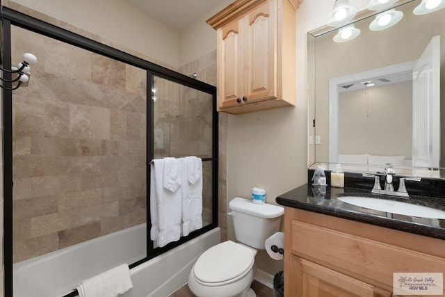 full bathroom with shower / bath combination with glass door, vanity, and toilet