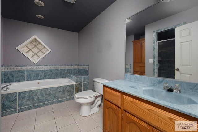 bathroom with tile patterned flooring, vanity, toilet, tiled shower, and a bath