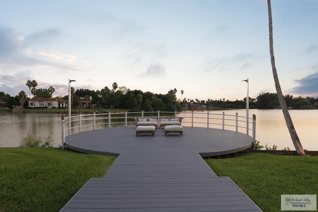 view of dock featuring a yard and a water view