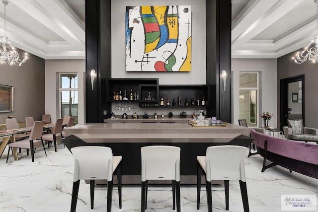 bar featuring decorative light fixtures, an inviting chandelier, a tray ceiling, and ornamental molding