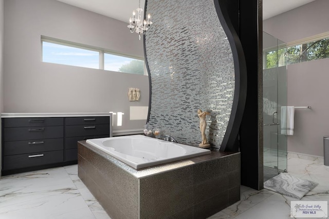 bathroom featuring a notable chandelier and independent shower and bath