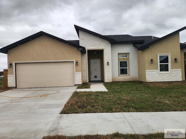 view of front of property featuring a garage and a front lawn