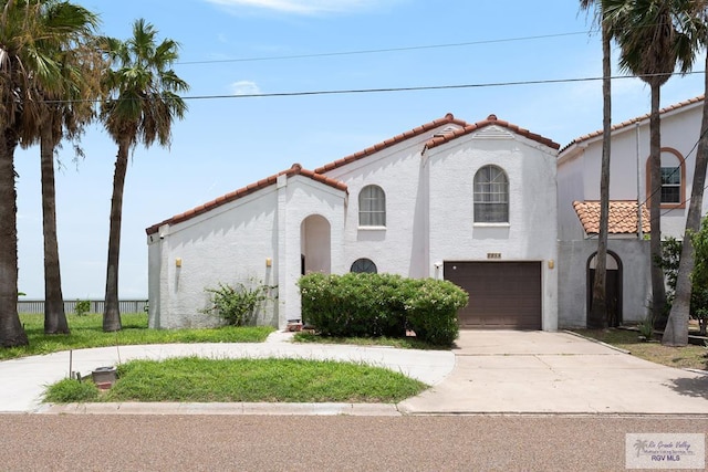 mediterranean / spanish home with a garage