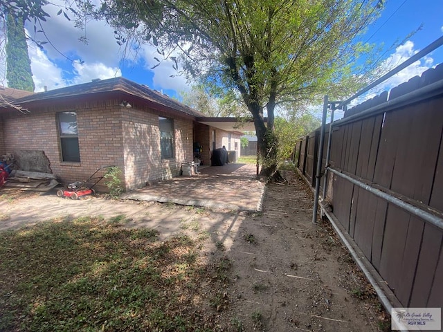 view of side of property featuring a patio