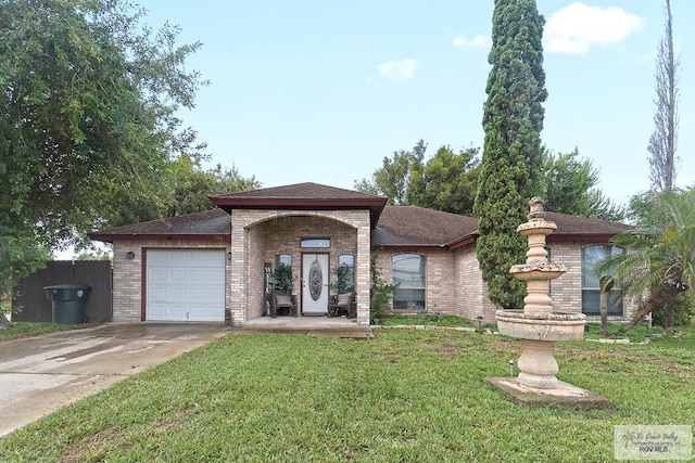 view of front of home with a front yard and a garage