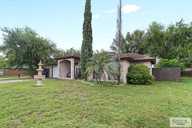 view of front of house with a garage and a front yard