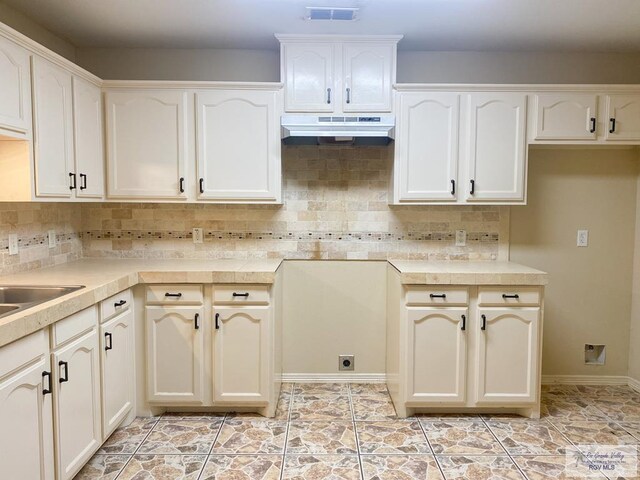 kitchen featuring decorative backsplash and light tile patterned flooring