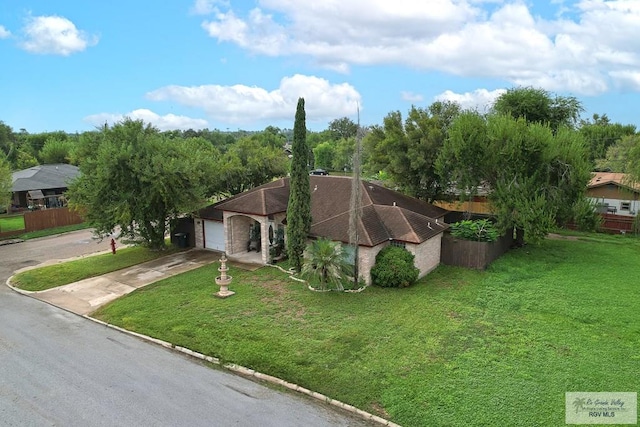 view of front of property featuring a garage and a front lawn