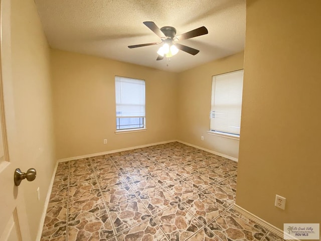 unfurnished room featuring ceiling fan, plenty of natural light, and a textured ceiling