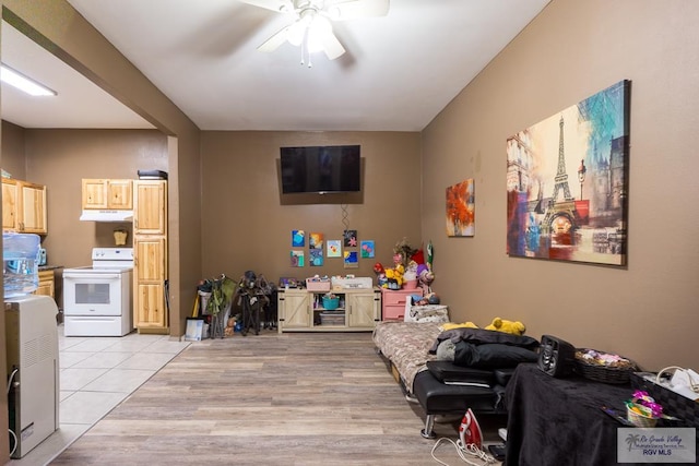 living area featuring a ceiling fan and light tile patterned flooring