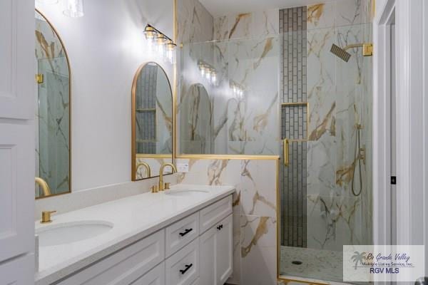 bathroom with vanity and a tile shower