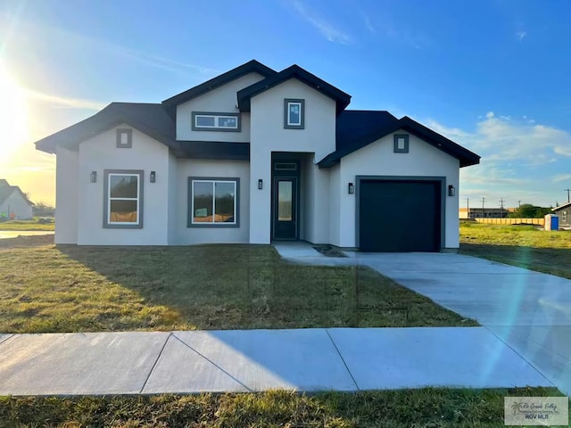 view of front of property with a garage and a front yard