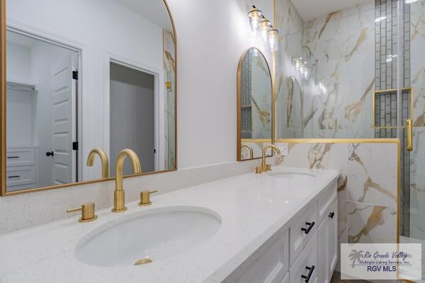 bathroom featuring vanity and a shower with shower door