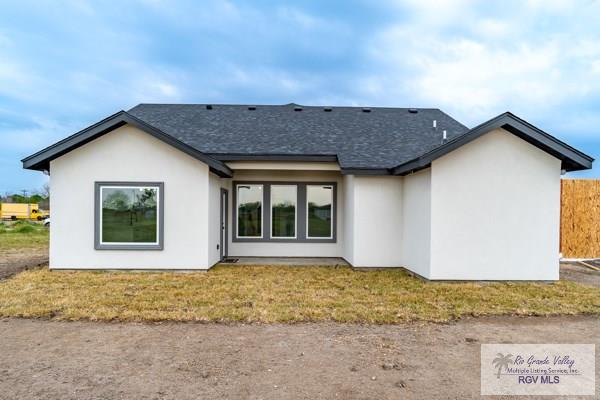 rear view of property with a lawn