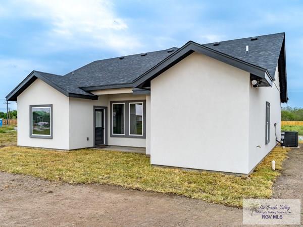 rear view of property with a lawn