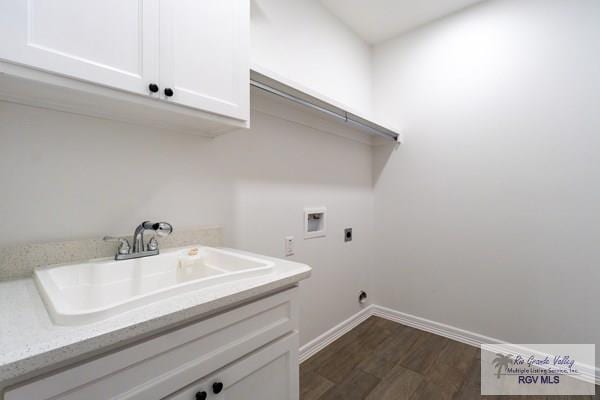 clothes washing area featuring dark wood-type flooring, sink, cabinets, washer hookup, and hookup for an electric dryer