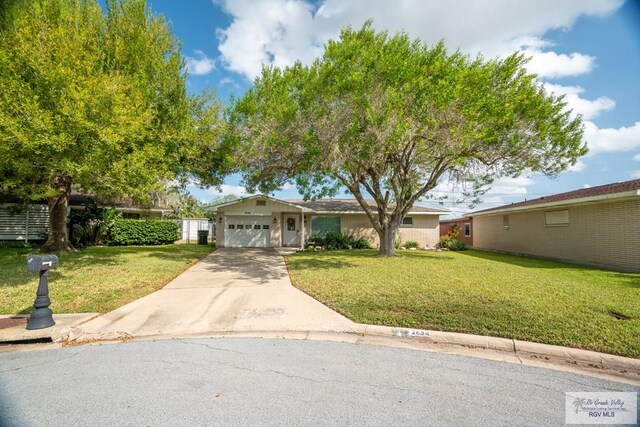 ranch-style home with a front yard and a garage