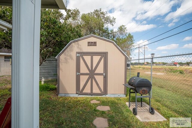 view of outbuilding featuring a lawn