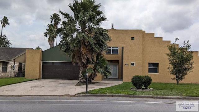 view of front of house featuring a garage and a front lawn