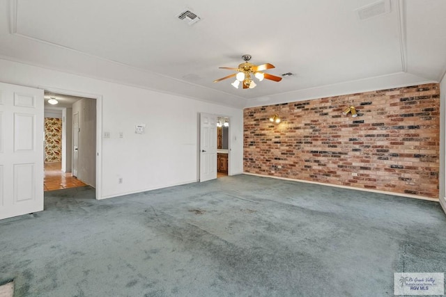 interior space with carpet floors, a ceiling fan, brick wall, and visible vents