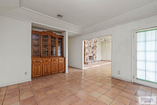 unfurnished room with a wealth of natural light and visible vents