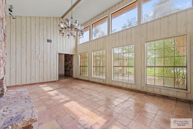 unfurnished sunroom featuring an inviting chandelier